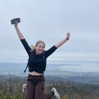 Woman on cliff jumping, happy